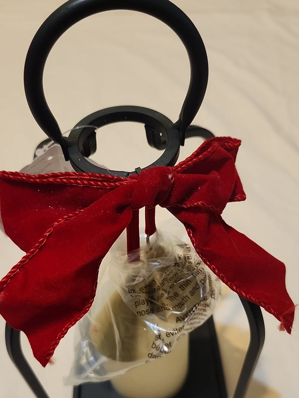 Decorative Lighted Black Metal Lantern with Red Bow and Cream Faux Candle